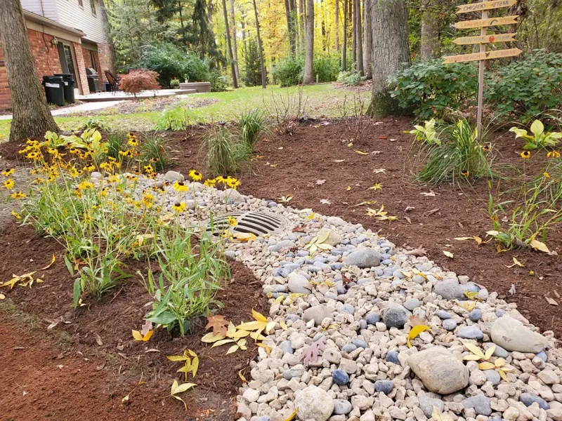 River-rock drainage bed with perennials